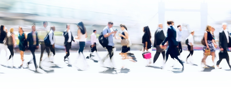 Busy sidewalk scene with people in business attire walking